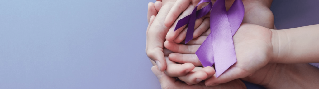 Several pairs of cupped hands, spanning age ranges, holding domestic violence awareness ribbons